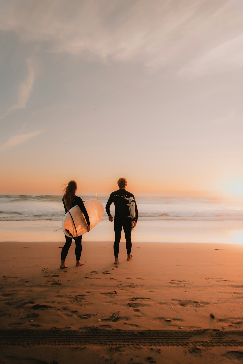 a couple of people that are standing in the sand