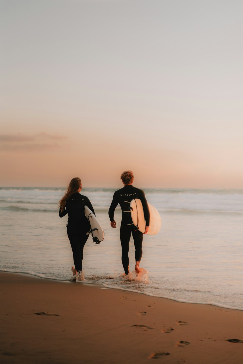 a couple of people that are walking in the water