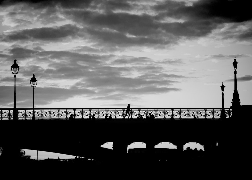 a person riding a bike across a bridge