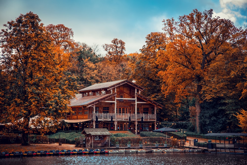 a house on a lake surrounded by trees
