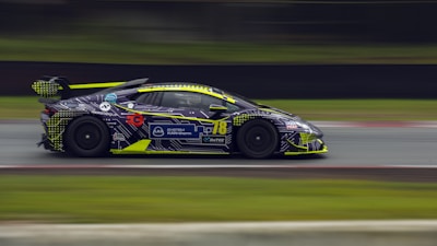 An intense moment captured from a fast-paced racing game featuring sleek cars and neon-lit tracks.