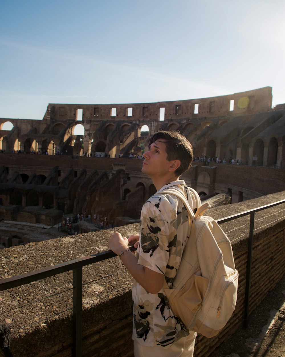 a man with a backpack looking up at the sky