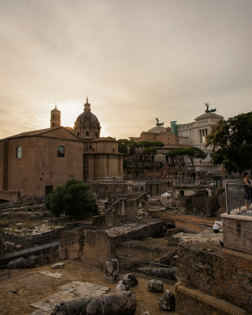 the sun is setting over the ruins of a roman city