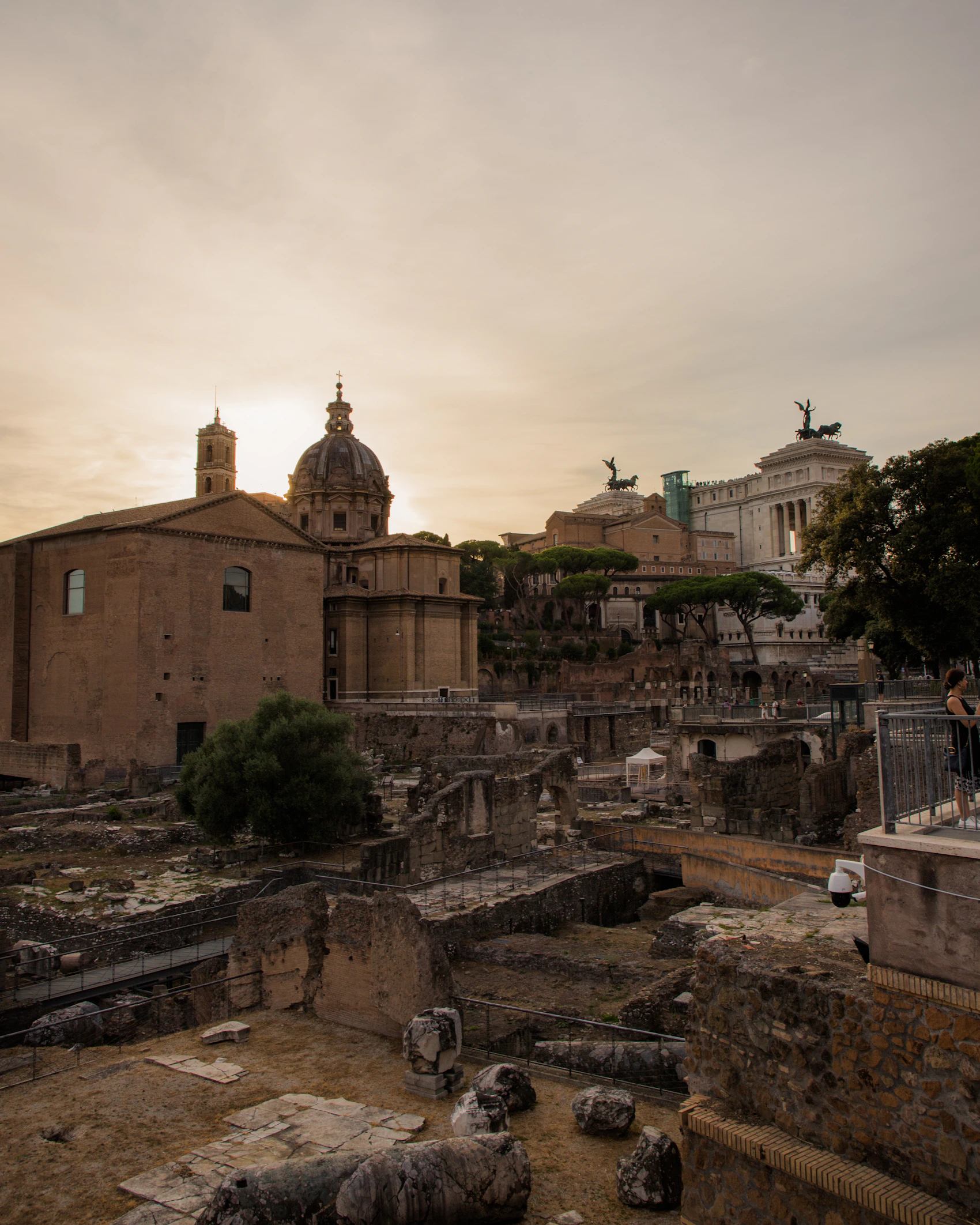 The ruins and columns of the Roman Forum glowing at sunset