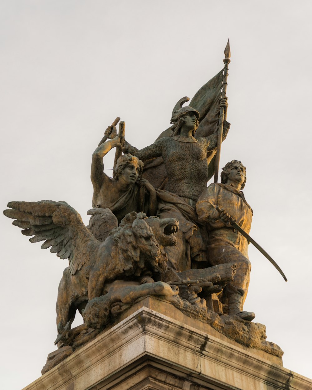 a statue of a man on a horse holding a flag