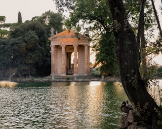 A tranquil view of a traditional Indian temple by a lake.