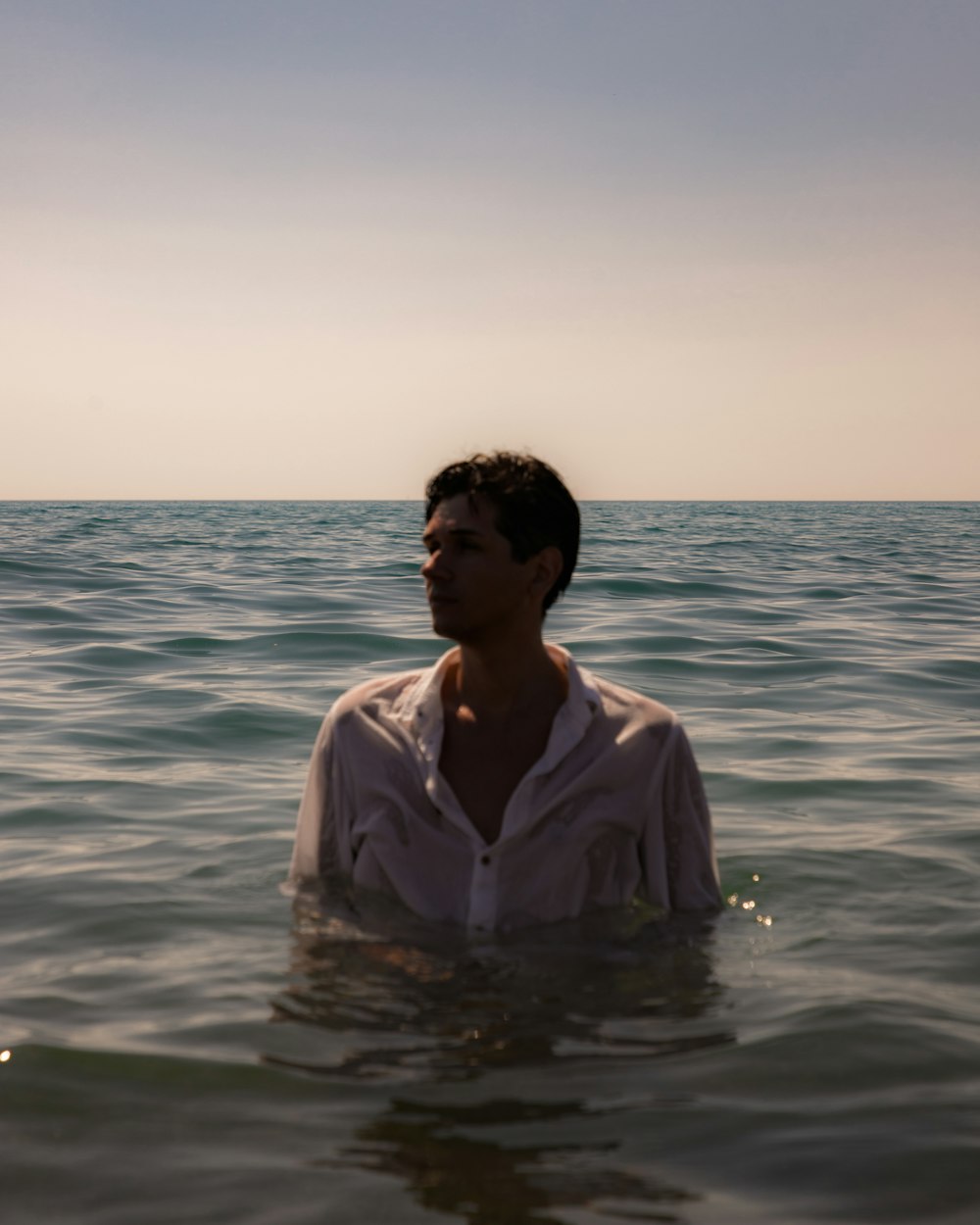 a man standing in the middle of a body of water