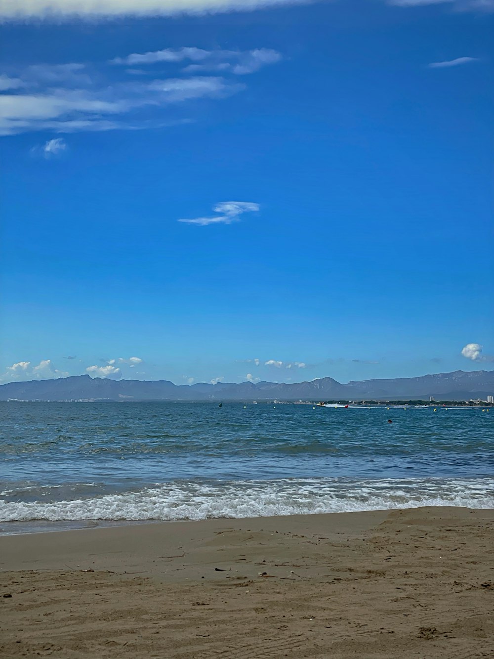 a person walking on the beach with a surfboard