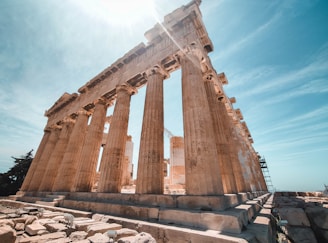 the sun shines brightly on the ruins of a temple