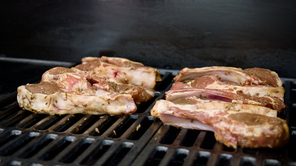 a close up of meat cooking on a grill