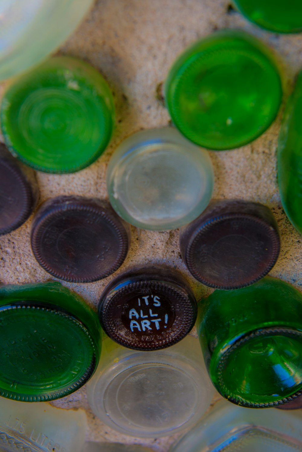 a group of green glass bottles sitting on top of a table