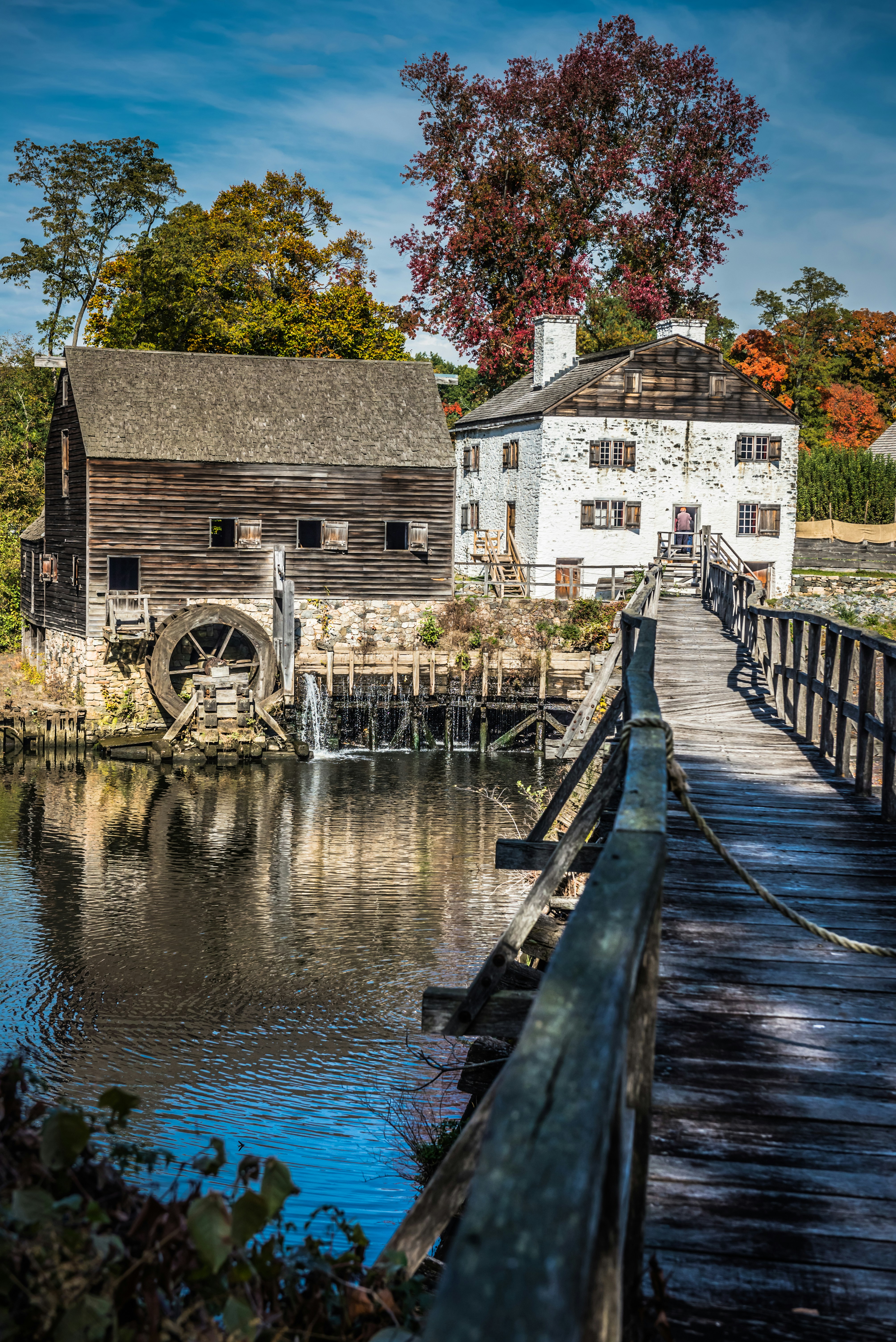 An old mill sits on the edge of a lake