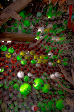 Colorful array of pesticide and fertilizer bottles arranged artistically on rustic wood.