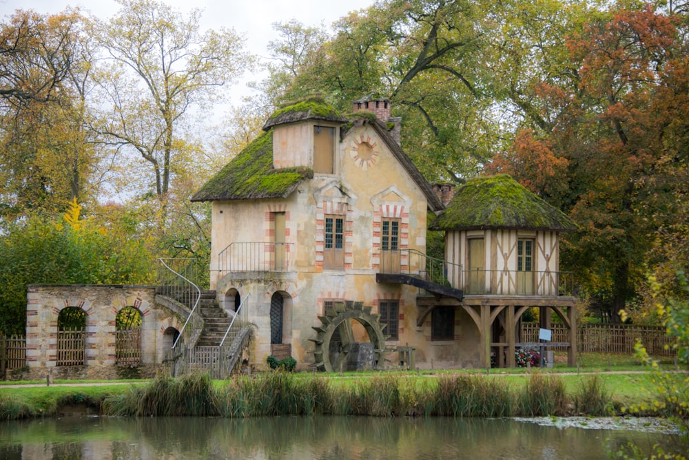 an old house with a pond in front of it