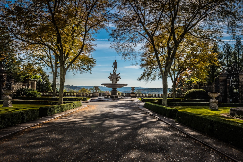 a road with a fountain in the middle of it