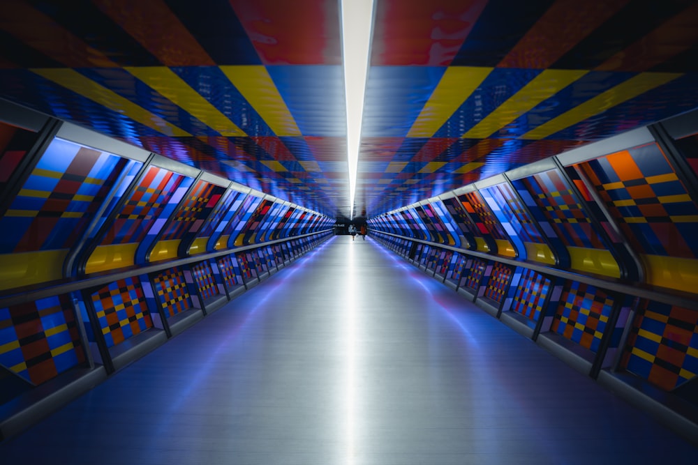 a very long hallway with a lot of colorful walls