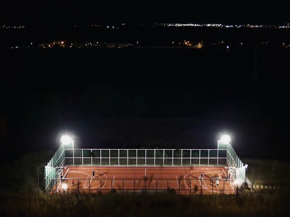 A cozy sports court with clear markings and evening lights ready for players.