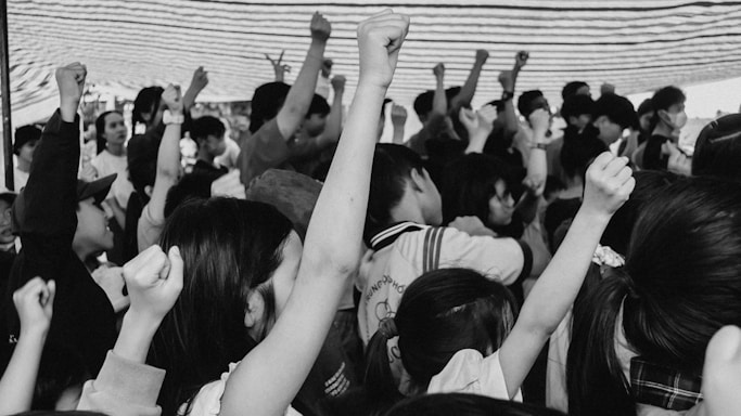 A diverse group of people standing together, united in determination and hope.