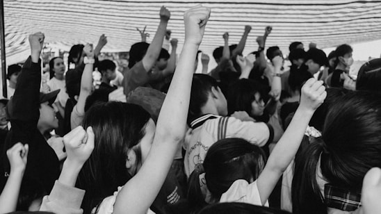 A warm group photo of diverse migrant workers and their families united in solidarity.