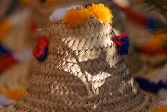 A sun hat being customized with vibrant embroidery.