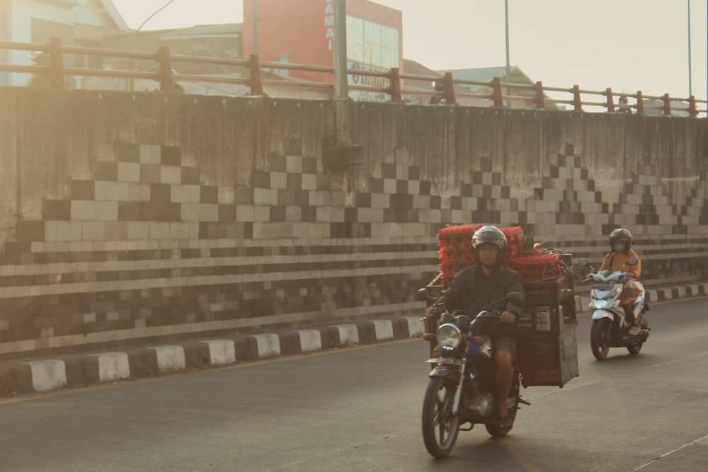 a group of people riding motorcycles down a street