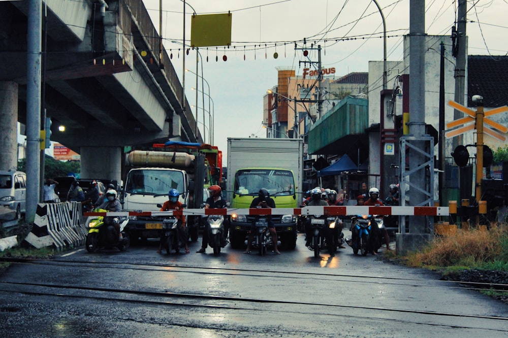 a group of people riding motorcycles down a street