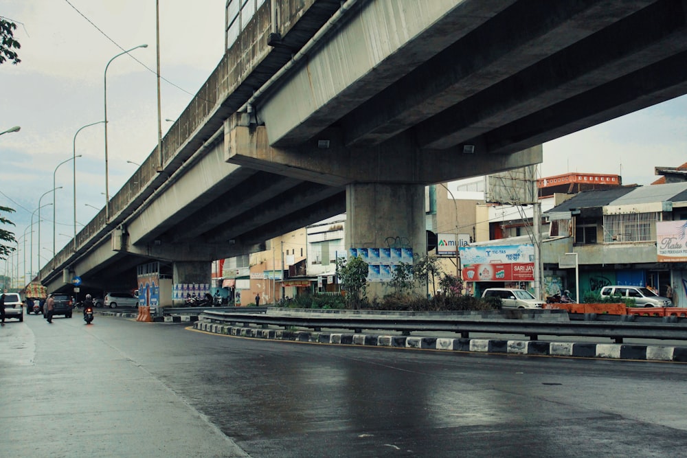 a city street with a bridge over it