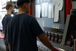 two men working on a machine in a factory