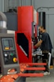 a man working on a machine in a factory