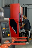 a man working on a machine in a factory