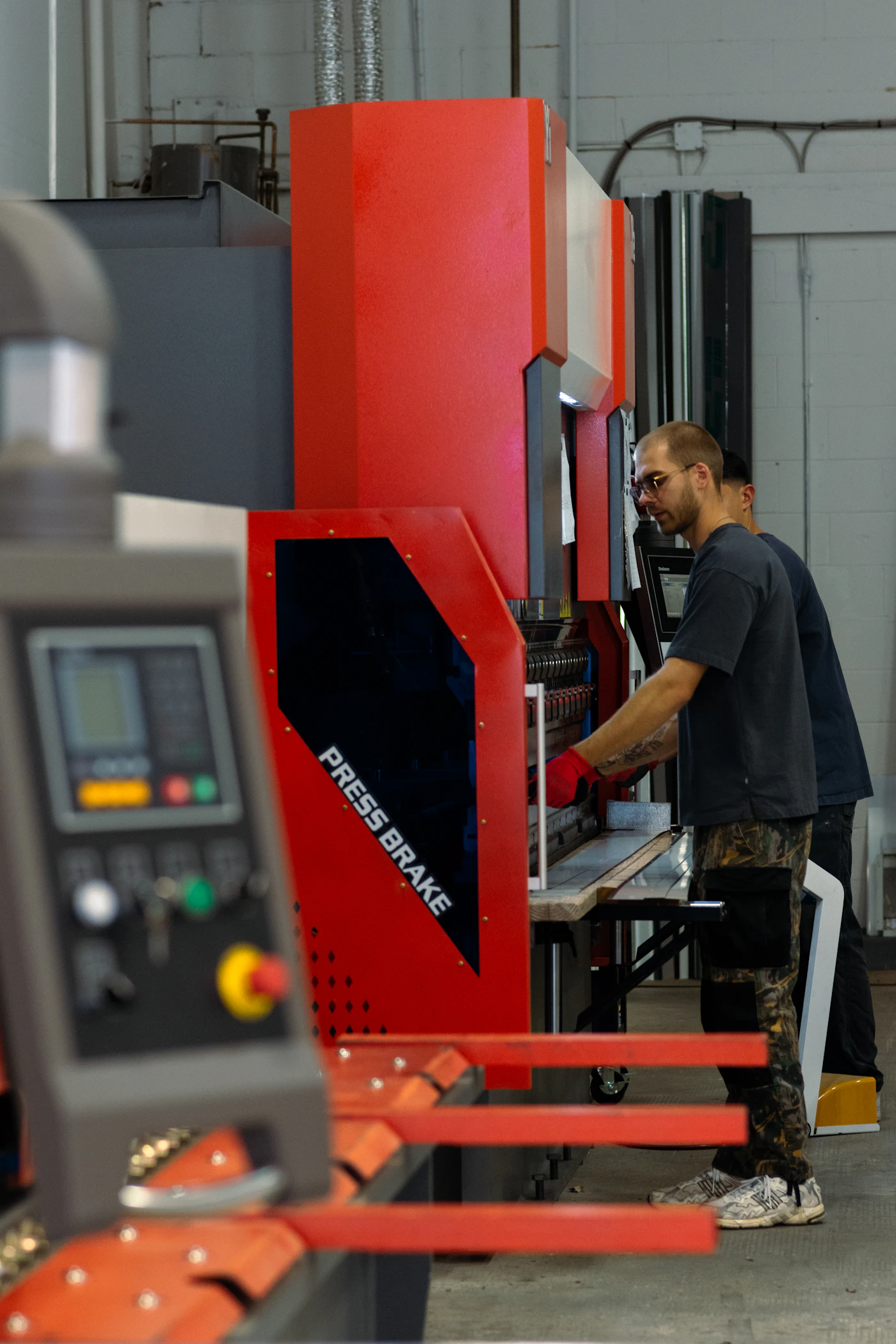 Manufacturing worker operating industrial production equipment