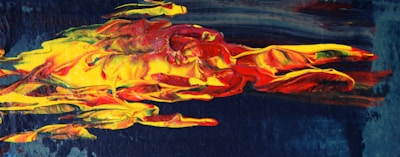 A bold abstract painting bursting with fiery reds and deep blues.