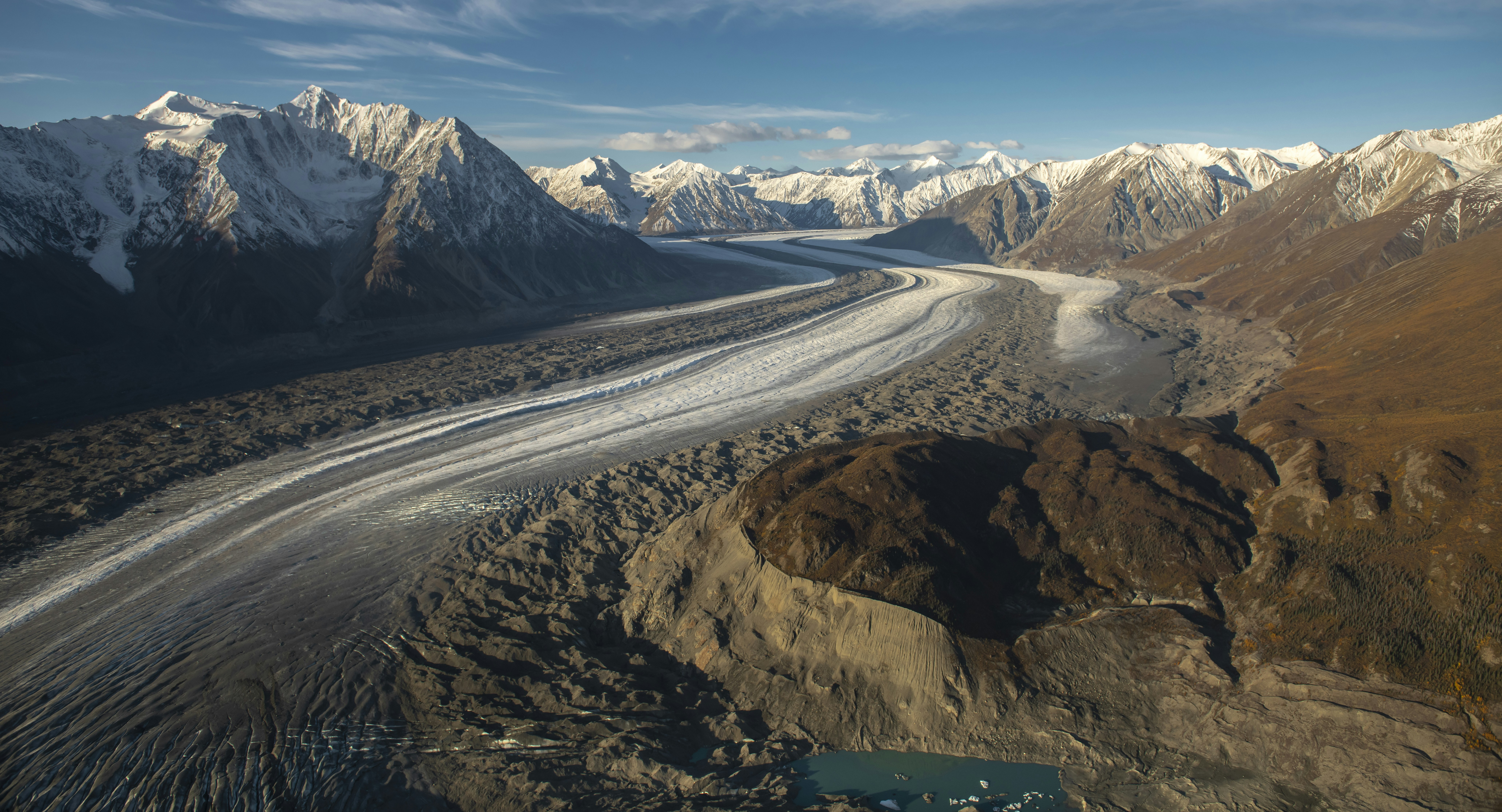 an aerial view of a glacier in the mountains, Aerial view of glacier