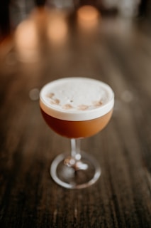 a drink sitting on top of a wooden table