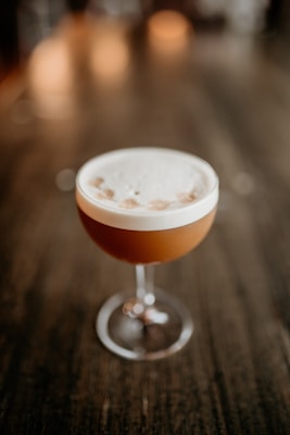 a drink sitting on top of a wooden table