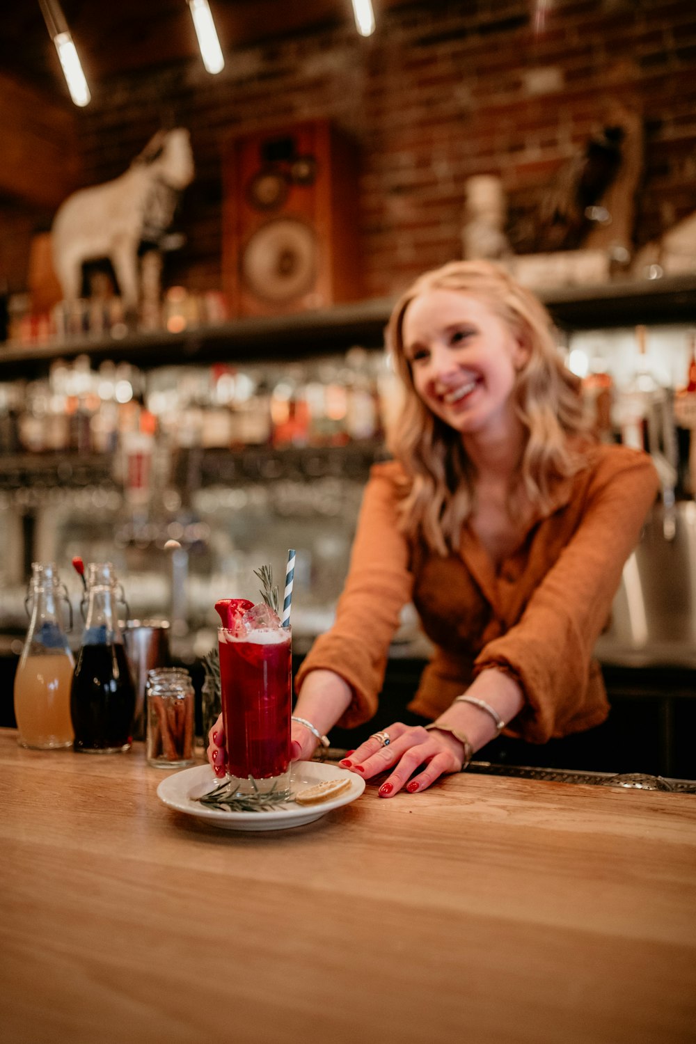 a woman sitting at a bar with a plate of food