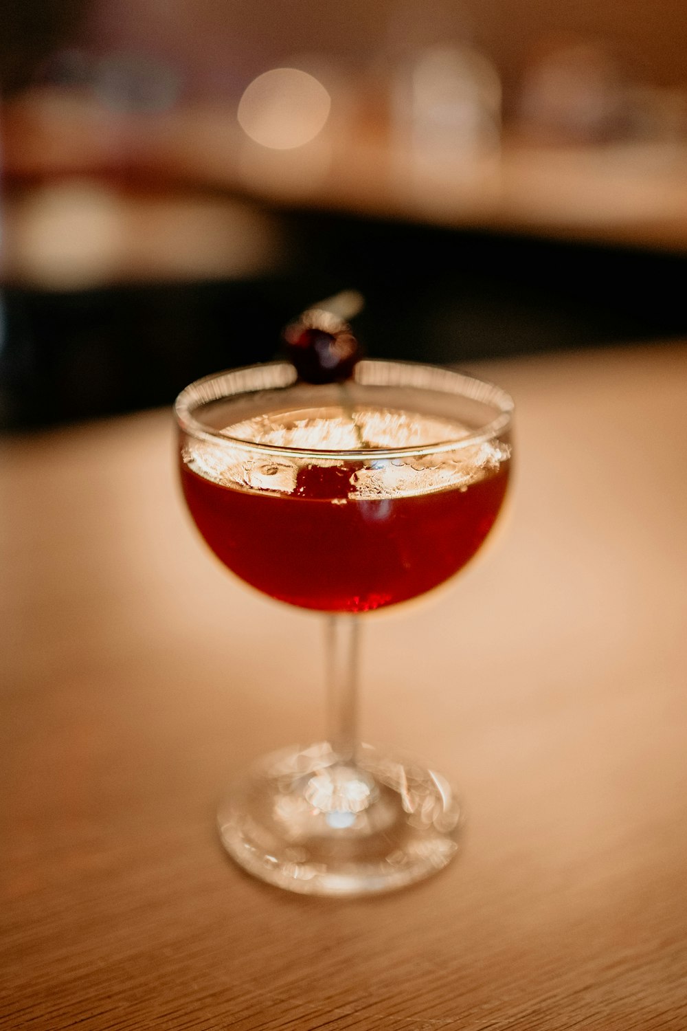 a close up of a wine glass on a table