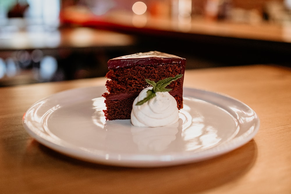 a piece of cake on a white plate on a table