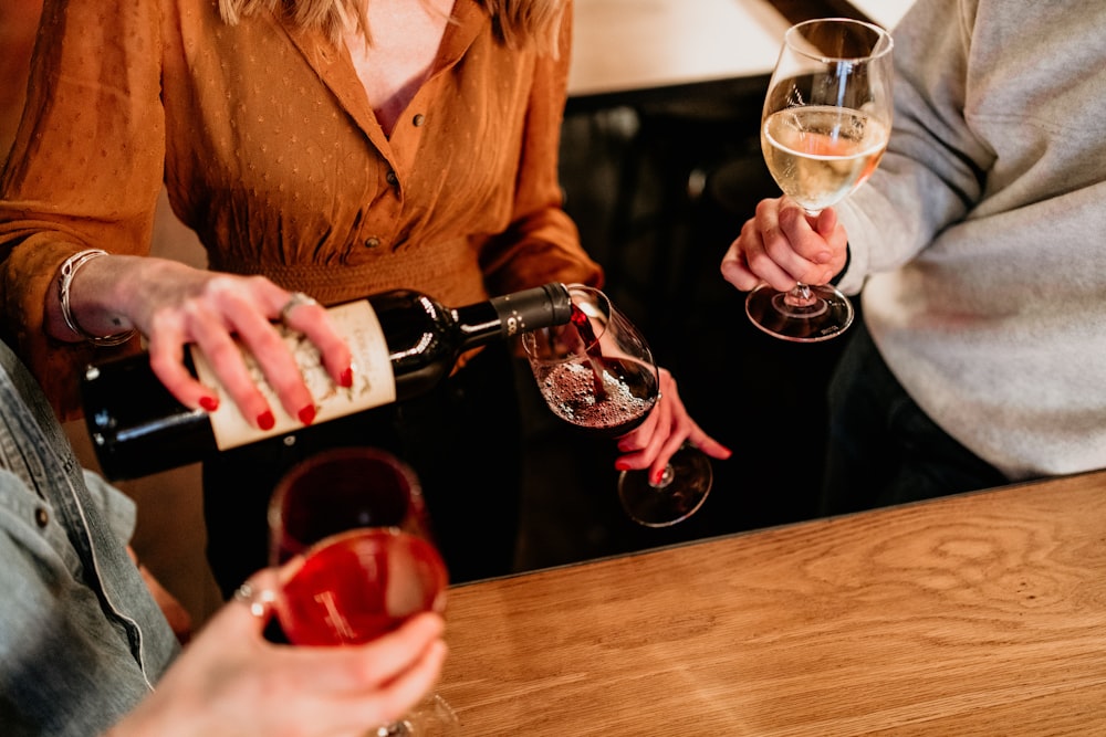 a group of people sitting at a table with wine glasses