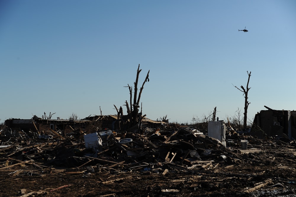 a plane flying over a pile of debris