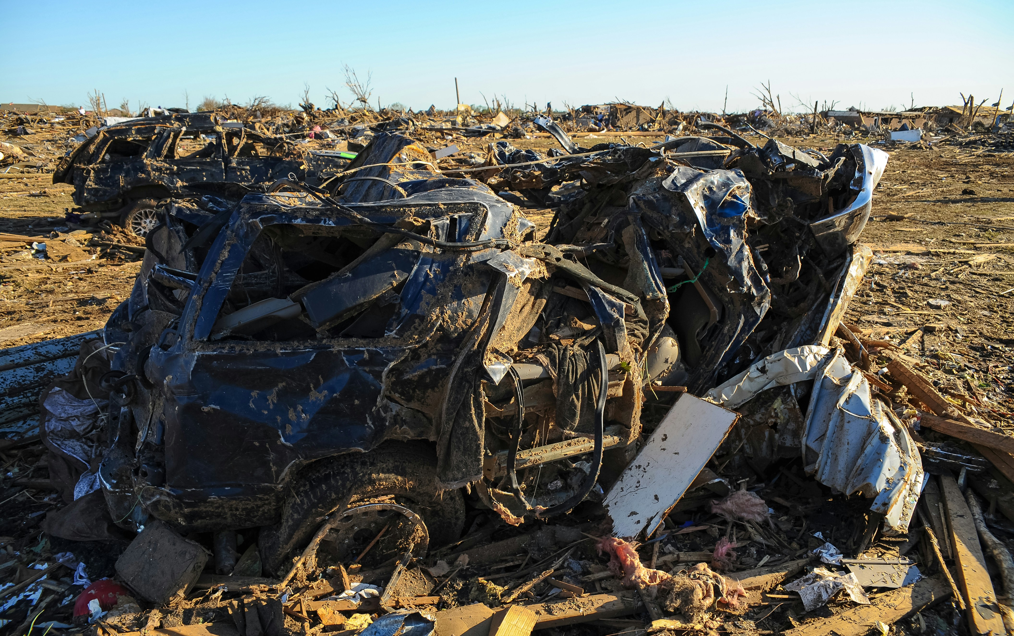 a pile of junk sitting on top of a dirt field