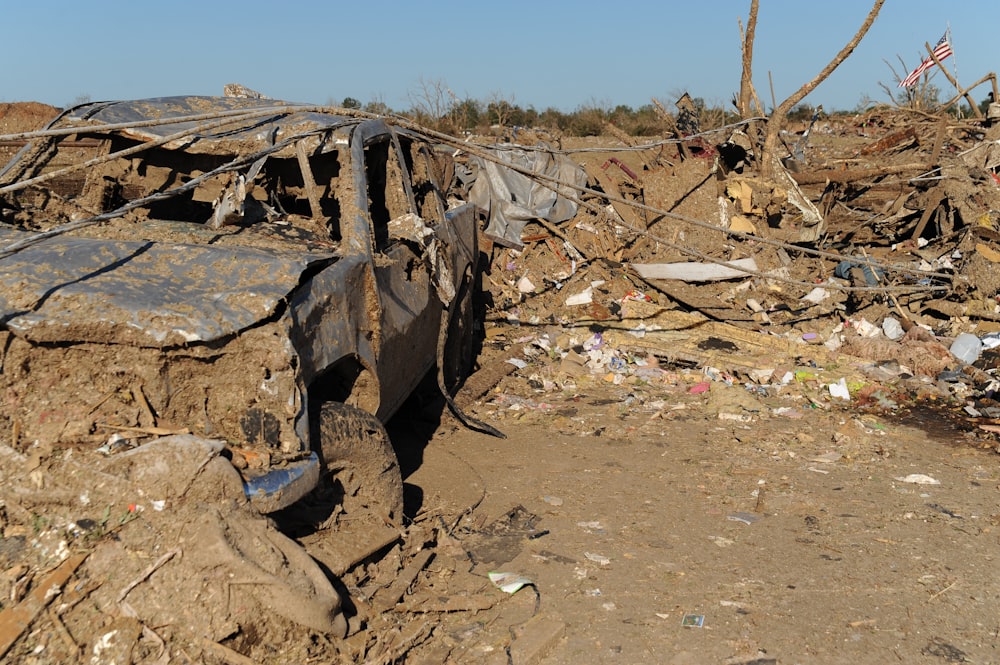 a pile of trash sitting on top of a dirt field