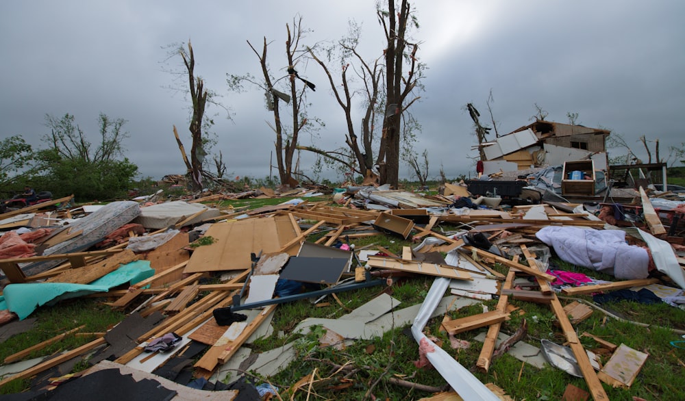 a pile of debris sitting on top of a lush green field