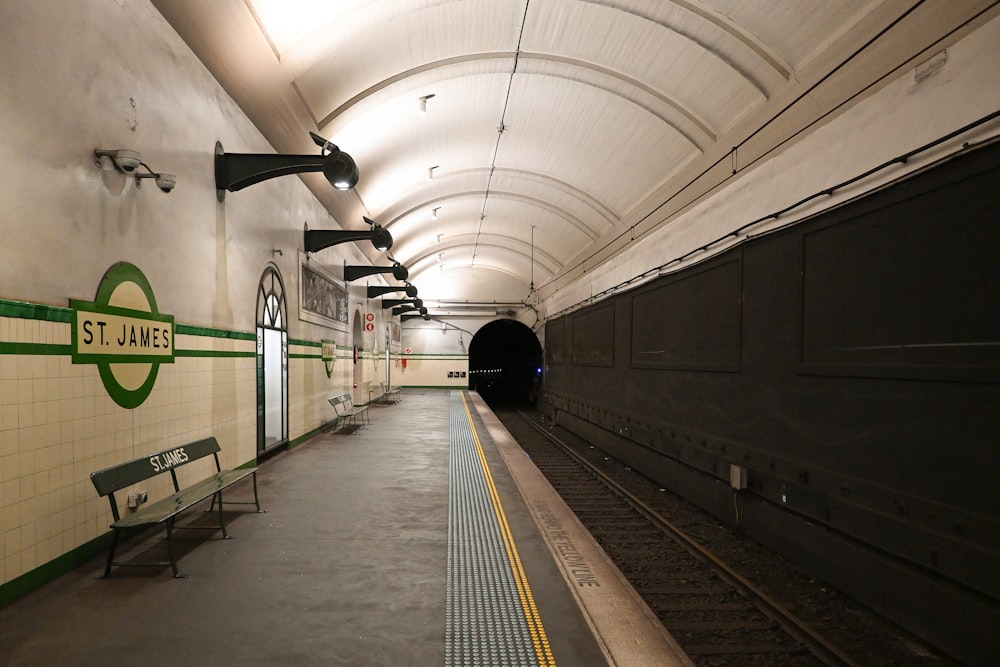 a subway station with a bench in the middle