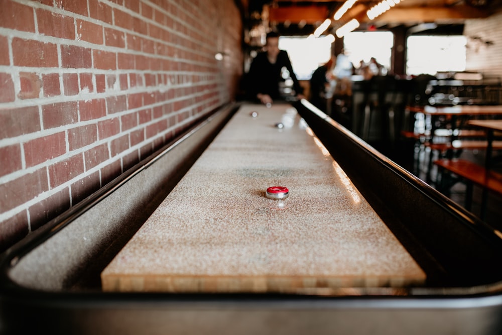 a close up of a table with a red object on it