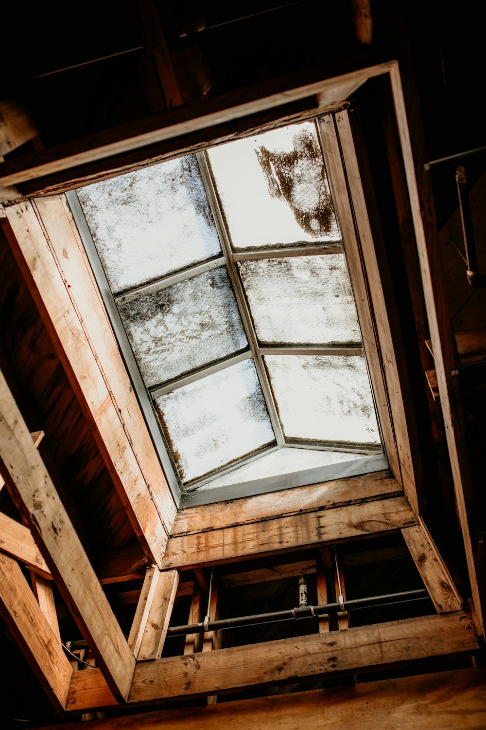 a wooden structure with a skylight inside of it