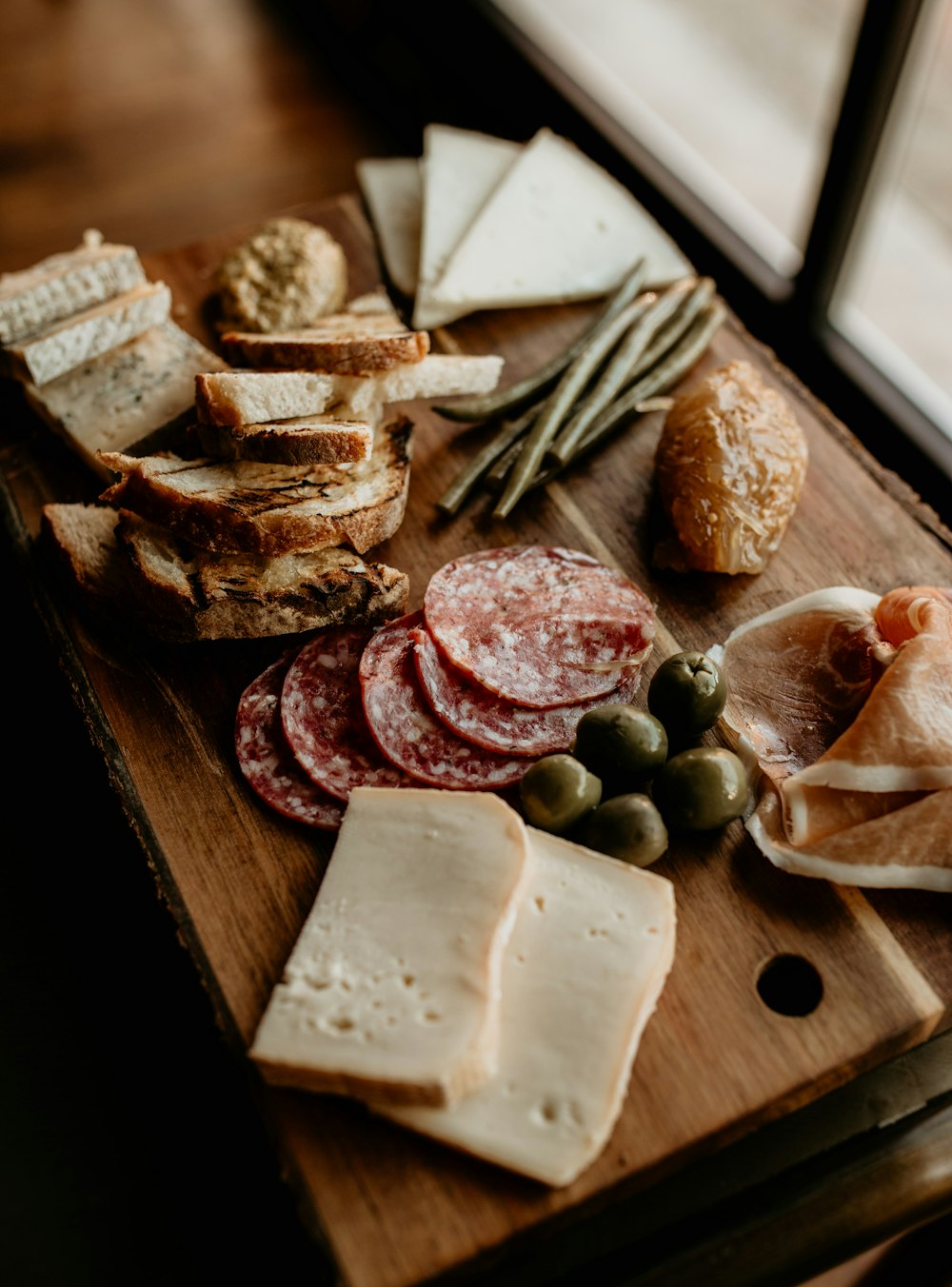 a wooden cutting board topped with lots of food