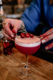 a close up of a person holding a drink
