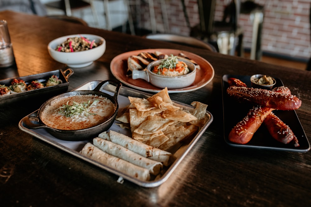 a wooden table topped with plates of food