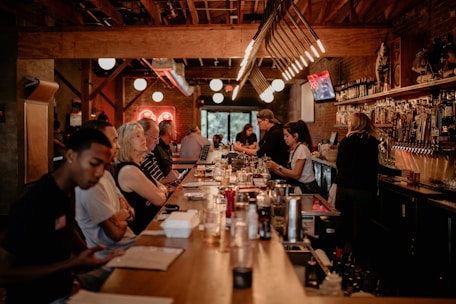 A cozy bar setting with drinks and a lively atmosphere.